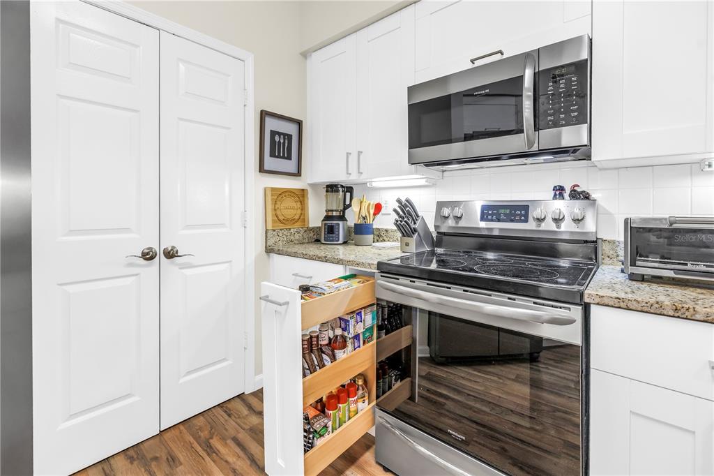 4206 Bay Club Circle, Unit 4206 Tampa, FL 33607 - Photo 12 of 60 a kitchen with stainless steel appliances a stove a microwave and cabinets