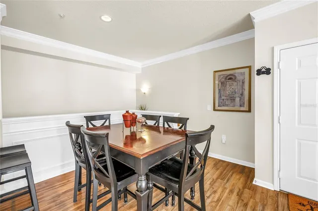 a living room with dining room and wooden floor
