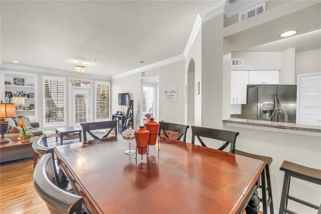 4206 Bay Club Circle, Unit 4206 Tampa, FL 33607 - Photo 15 of 60 a living room with dining room and wooden floor