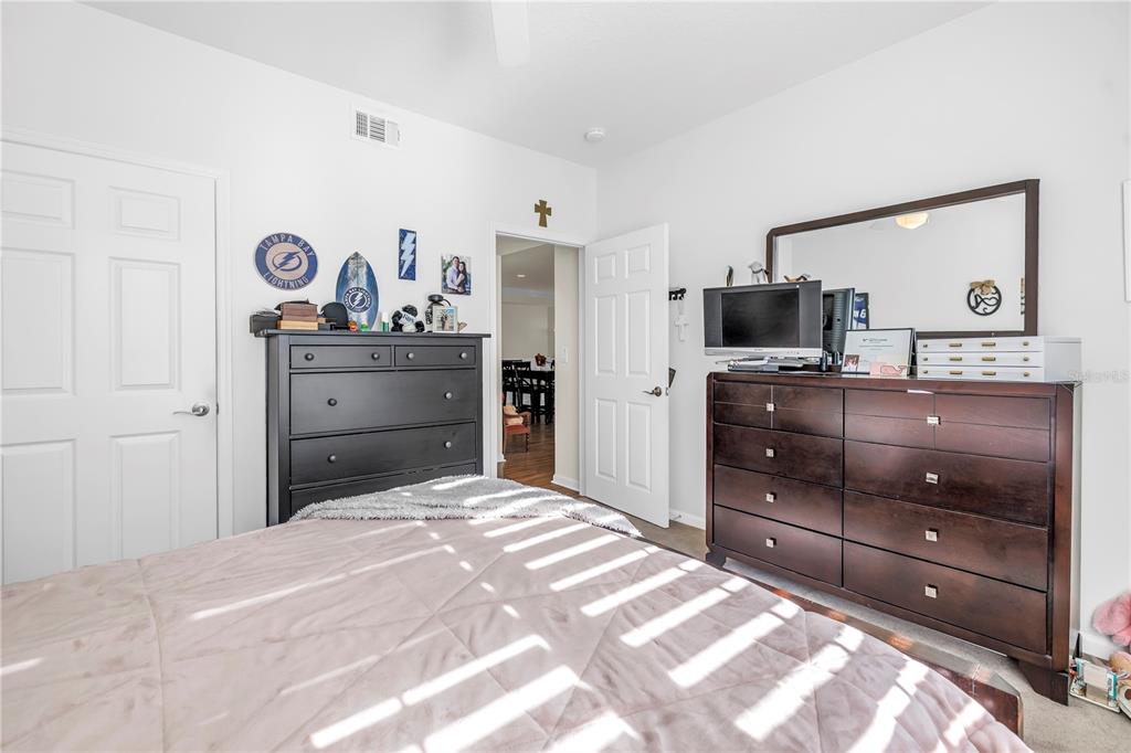 4206 Bay Club Circle, Unit 4206 Tampa, FL 33607 - Photo 18 of 60 a bedroom with a bed and a dresser