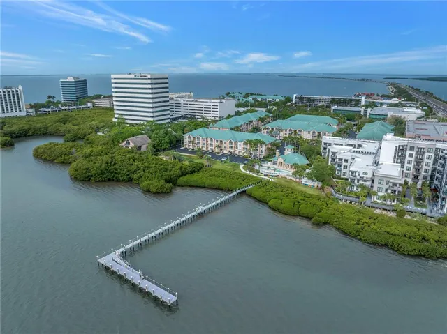 a kitchen with a sink dishwasher a stove and white cabinets with wooden floor