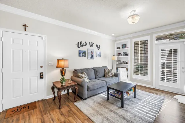 a living room with furniture and two window