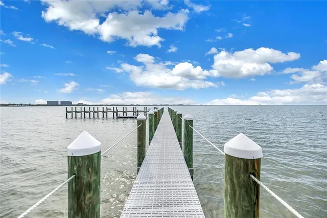 a view of a chairs and table in the back yard of the house