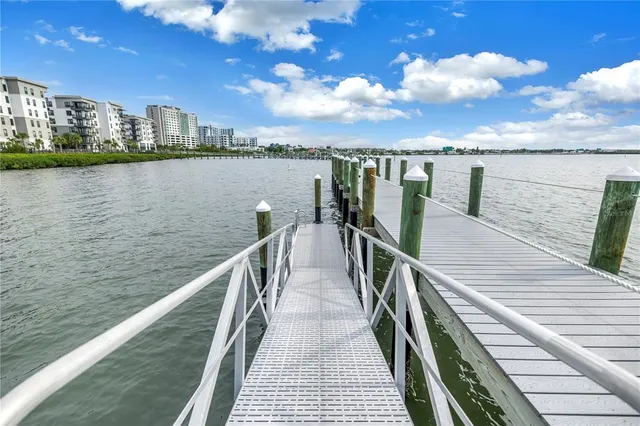 a view of a dining room with furniture a rug and a large window