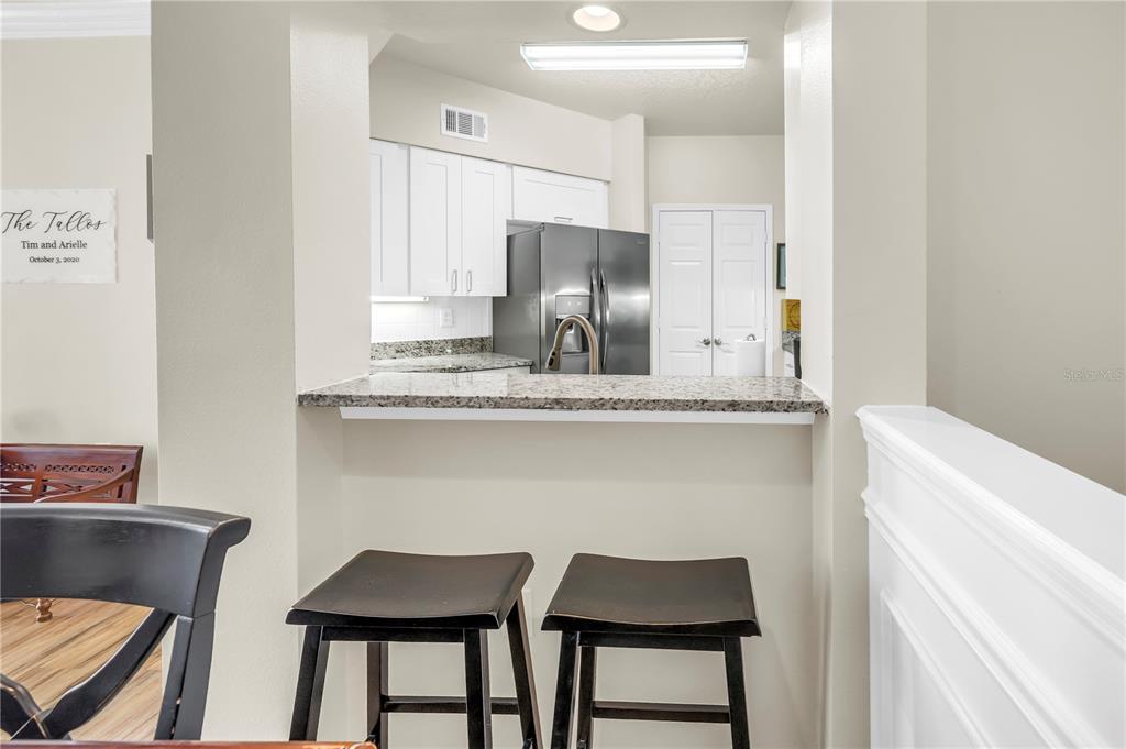 4206 Bay Club Circle, Unit 4206 Tampa, FL 33607 - Photo 8 of 60 a kitchen with stainless steel appliances a dining table chairs and a refrigerator