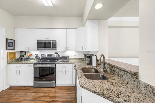a kitchen with a refrigerator and cabinets
