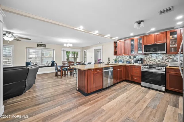a kitchen with a sink counter top space and stainless steel appliances