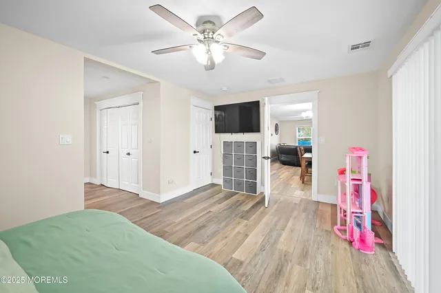 a view of livingroom with hardwood floor and a ceiling fan