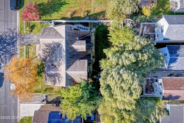 aerial view of a house with a yard and garden