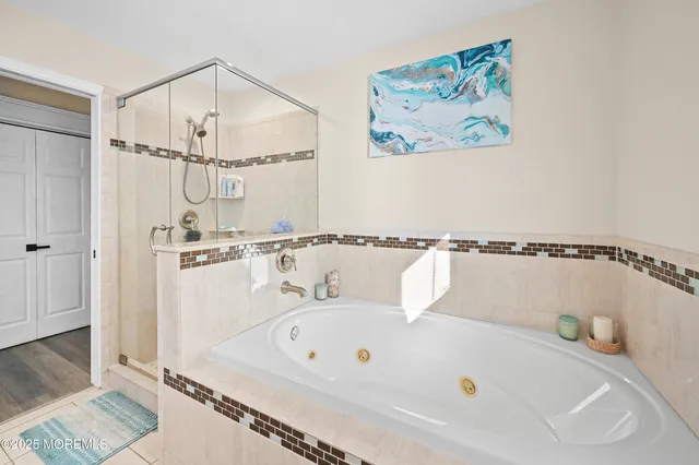 a bathroom with a bathtub and a shower