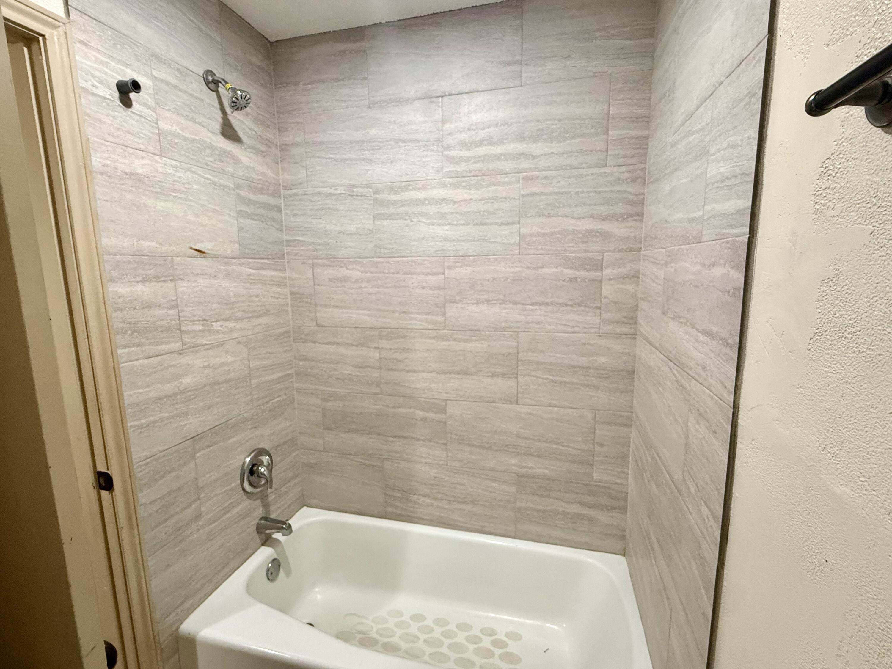 6304 Quaker Avenue Lubbock, TX 79413 - Photo 11 of 20 a bathroom with a bathtub