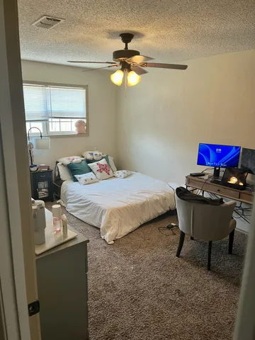 a bedroom with a bed and a table in it