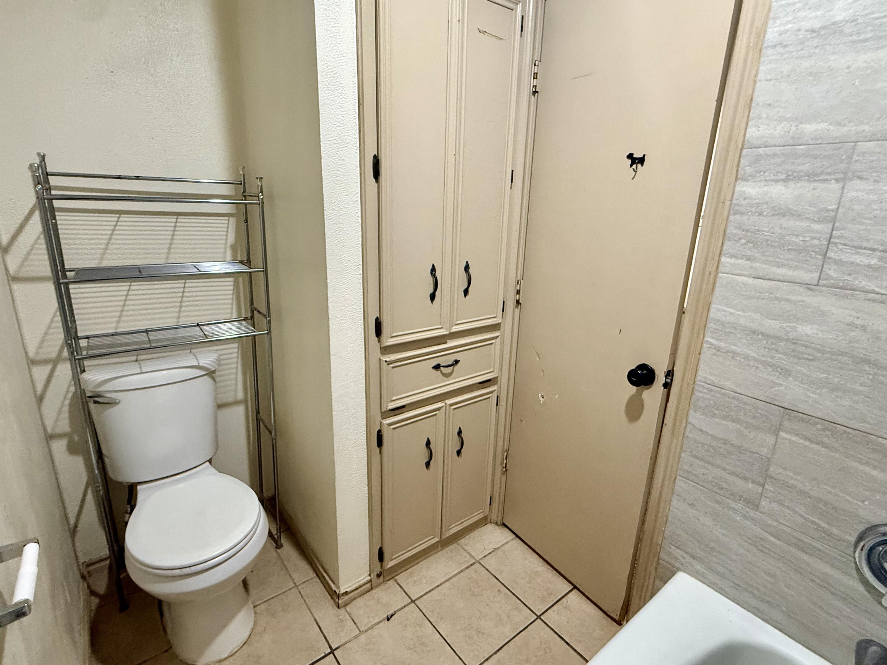 6304 Quaker Avenue Lubbock, TX 79413 - Photo 10 of 20 a bathroom with a toilet and a shower