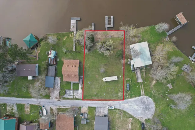 an aerial view of a house with a lake view