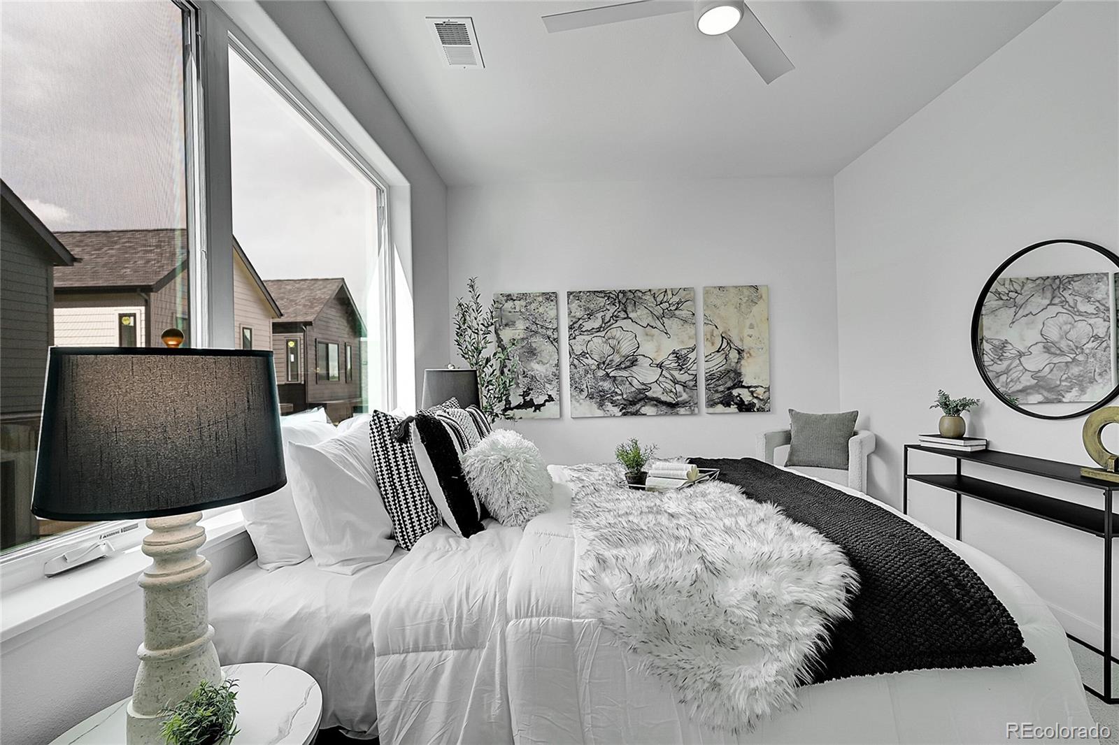 765 East County Line Road Erie, CO 80516 - Photo 18 of 28 a bedroom with a large bed and a large window