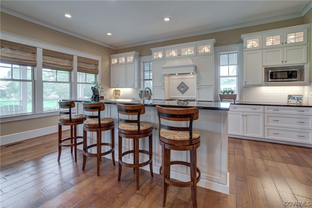 34 Crabshell Lane Kilmarnock, VA 22482 - Photo 13 of 50 a kitchen with stainless steel appliances granite countertop table chairs stove and wooden floor