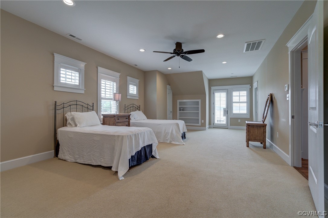 34 Crabshell Lane Kilmarnock, VA 22482 - Photo 27 of 50 a spacious bedroom with a bed a couch and a window