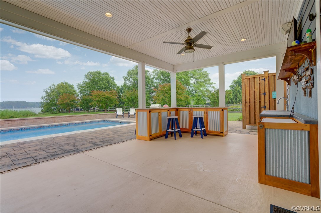 34 Crabshell Lane Kilmarnock, VA 22482 - Photo 35 of 50 a view of a patio with table and chairs and potted plants