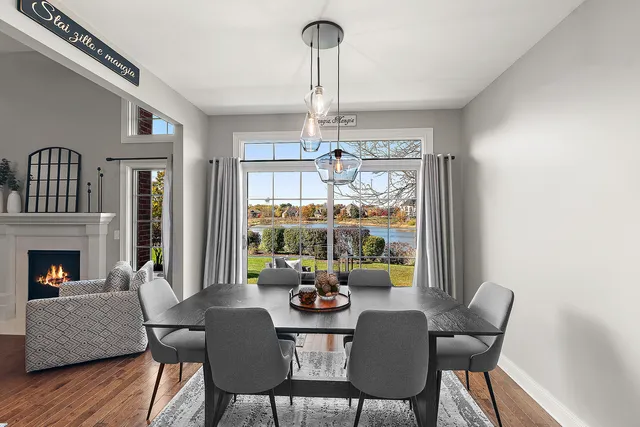 a dining room with furniture a chandelier and wooden floor