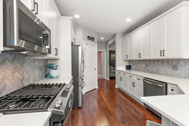 a kitchen with stainless steel appliances granite countertop a stove and a refrigerator