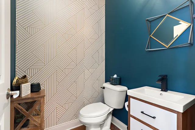 a bathroom with a sink a toilet and a mirror