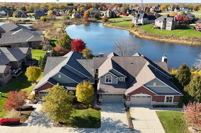 an aerial view of a house with a lake view
