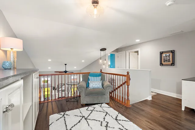 a bedroom with furniture wooden floor and a chandelier