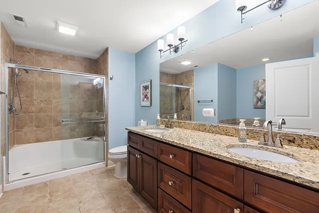 a bathroom with a granite countertop sink mirror and bathtub