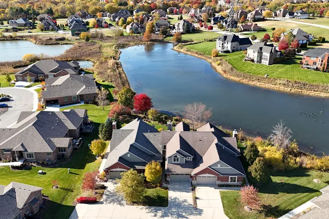an aerial view of a house with swimming pool and ocean view