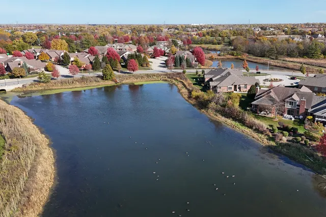 an aerial view of a house with a lake view