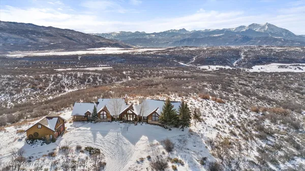 a view of a dry yard with mountains in the background