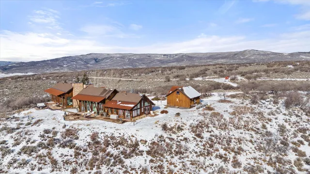 a living room with furniture fireplace and a large window