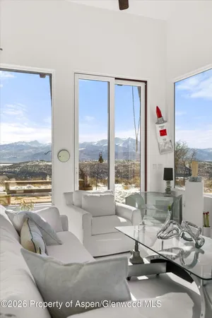 a bedroom with a bed and a view of balcony