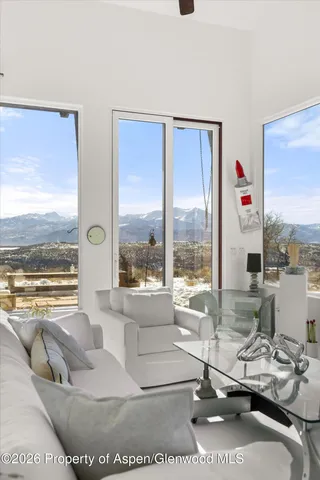 a bedroom with a bed and a view of balcony