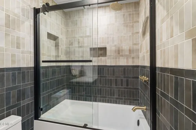 a bathroom with a bathtub and a shower