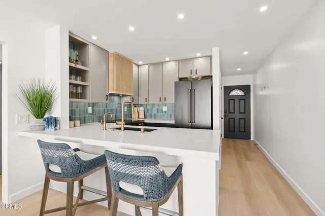 a large kitchen with a table and chairs