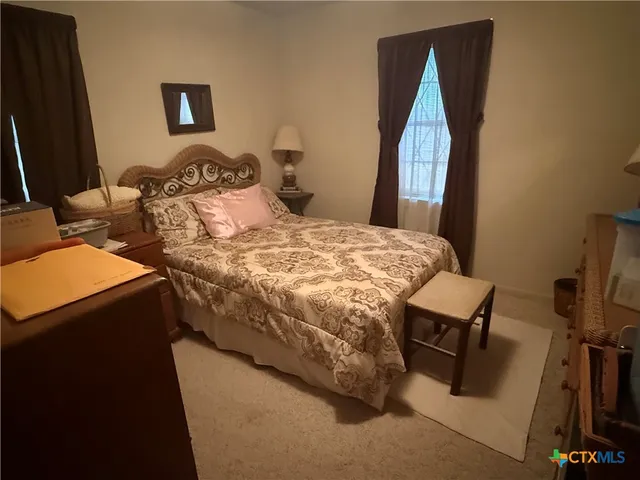 a bedroom with a bed and cabinets