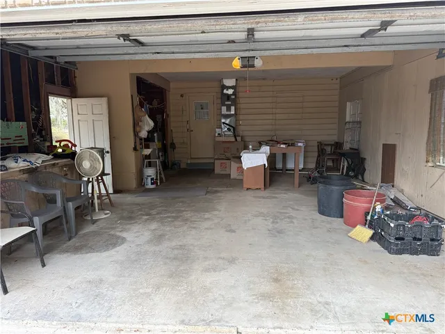 a kitchen with white cabinets and sink