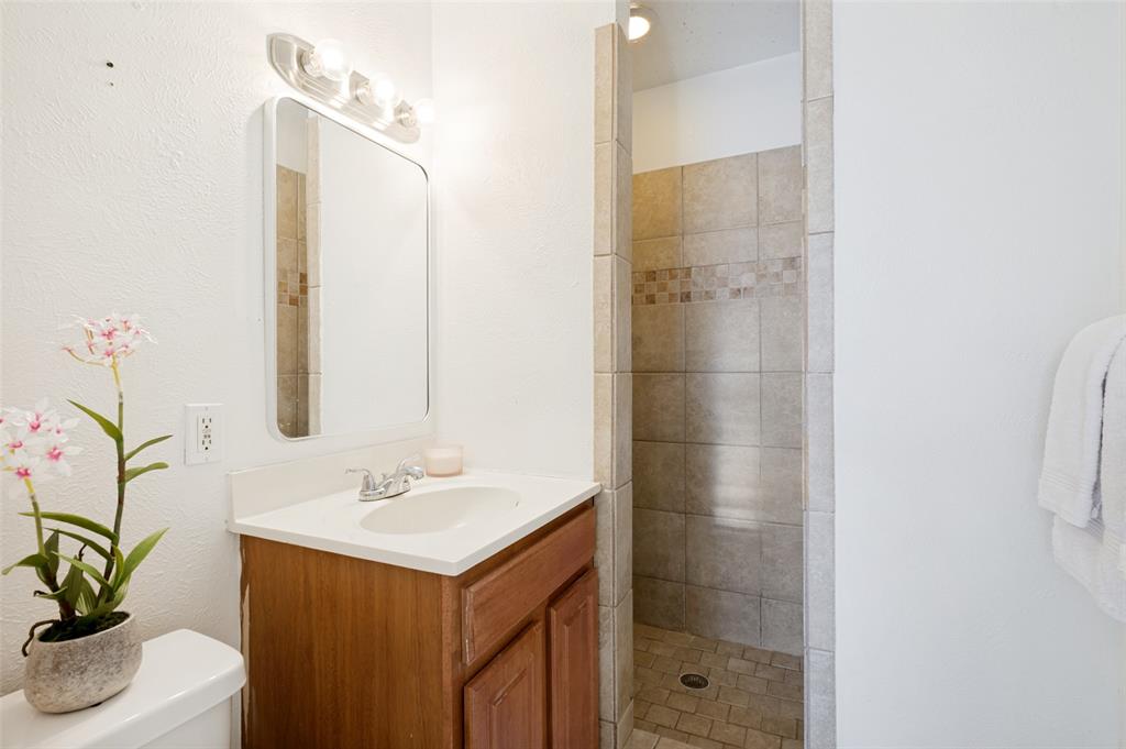 709 East Main Street Pilot Point, TX 76258 - Photo 7 of 11 a bathroom with a sink and a mirror