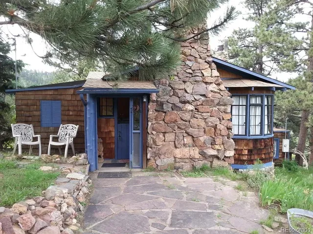 a view of a chair and table in backyard of the house