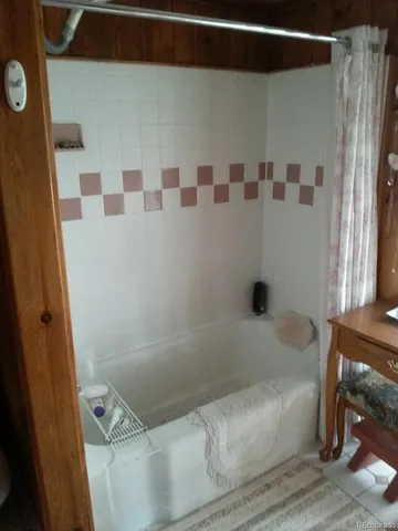 a bathroom with a bathtub and shower
