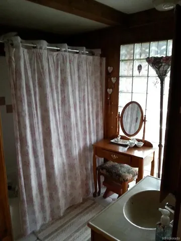 a bathroom with a toilet and a mirror