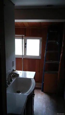 a room with wooden cabinets and a sink