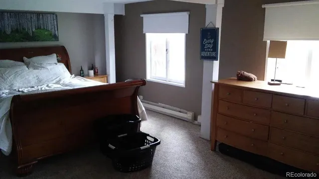 a bed sitting in a bedroom next to a window