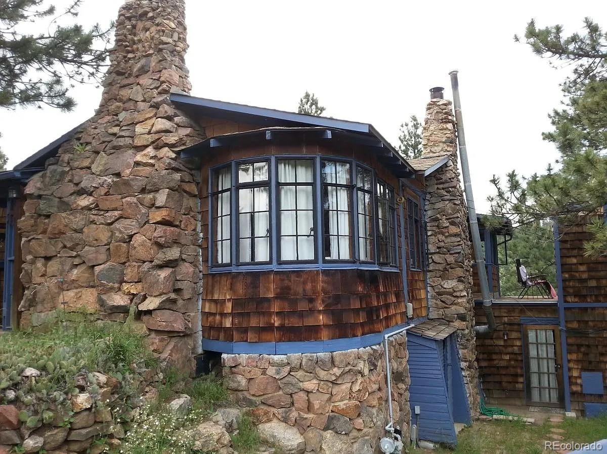 26079 Kingsbury Road Kittredge, CO 80457 - Photo 2 of 28 a front view of a house with a yard