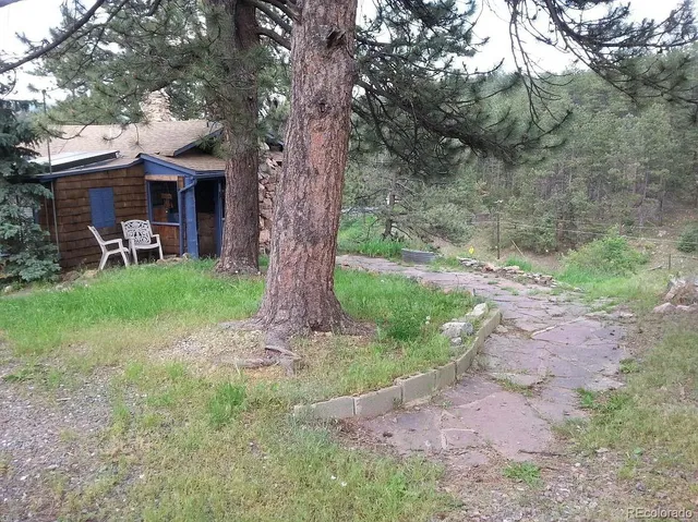 a view of a house with backyard porch and sitting area