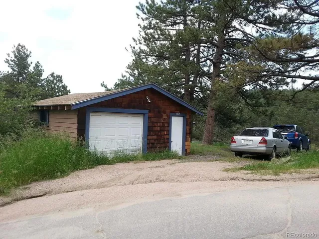 a yellow house with trees in front of it