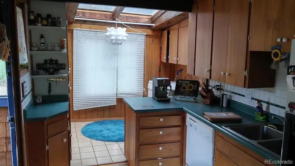 a kitchen with a refrigerator and a sink