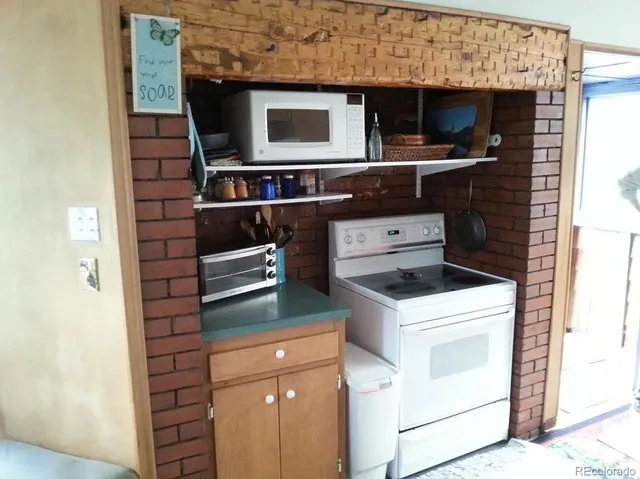 a kitchen with a stove and a microwave