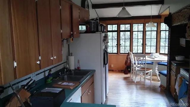 a dining room with furniture and wooden floor